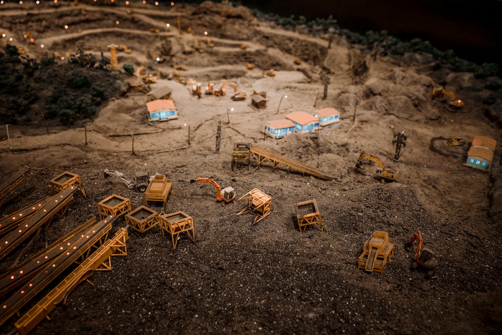 Photo by HONG SON Close-up of a detailed miniature construction site showcasing a quarry with machinery and structures.