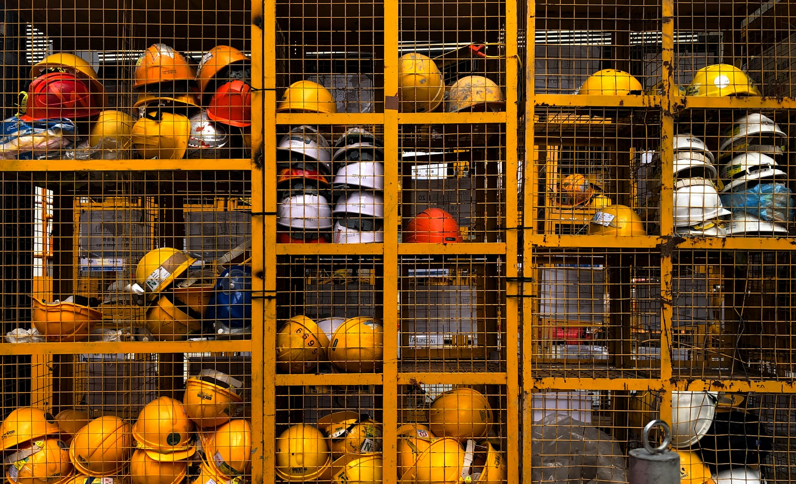Photo by Pop & Zebra a rack filled with lots of yellow hard hats